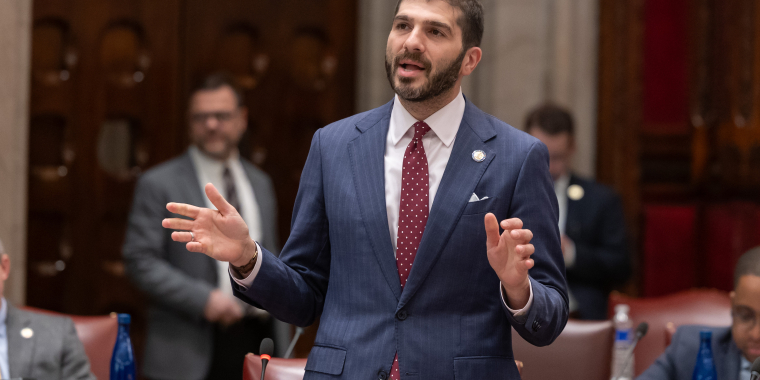Senator Andrew Gounardes speaking in the State Senate chamber..