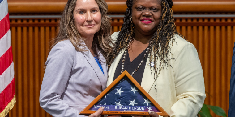 Senator Webb and Dr.Susan Herson holding the flag