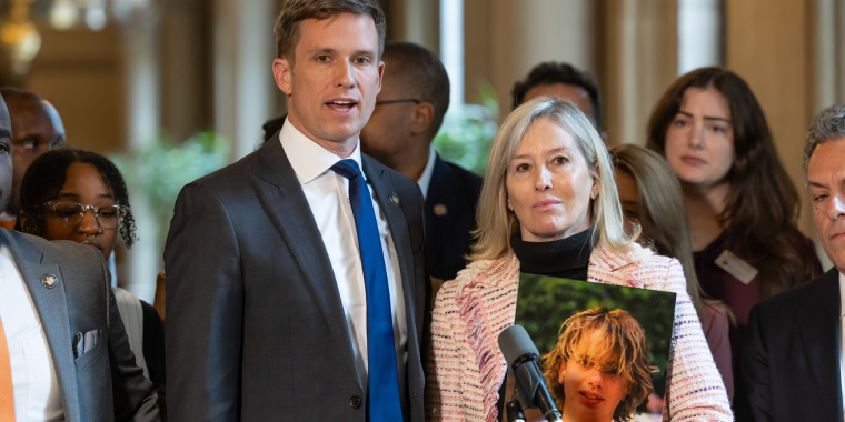 Senator Erik Bottcher and Diana Cochran, Francesco's mother, stand together at a press conference speaking to the media.