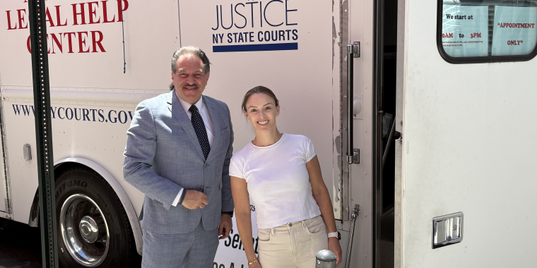Senator Addabbo greets Kyle Koeppel Mann, an attorney with NYLAG.