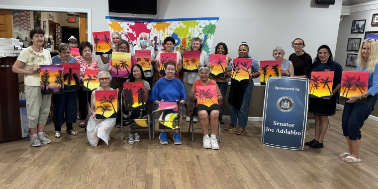 Everyone posed for a group photo displaying their art.