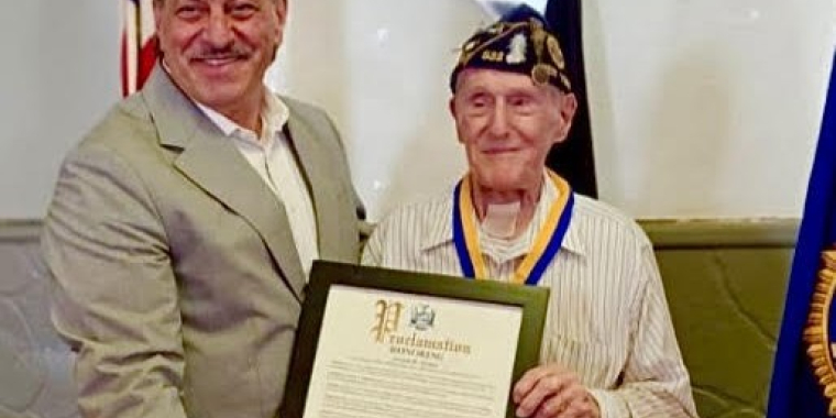 Senator Addabbo presents veteran Joseph R. Arcara with a proclamation and a Liberty Medal.