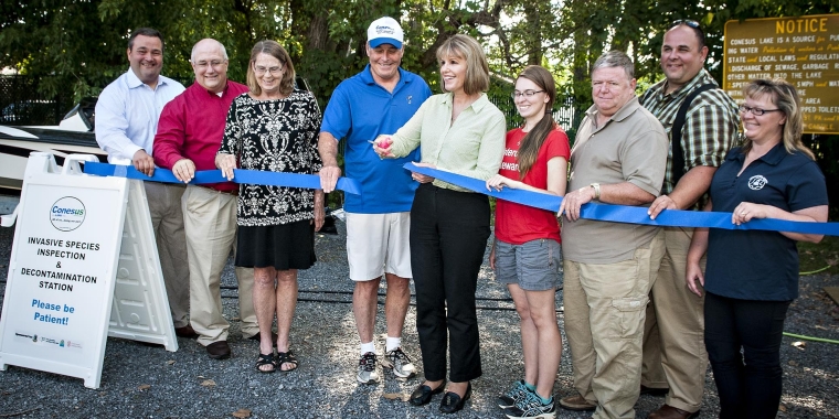 Senator Young cuts the ribbon on the Conesus Lake Boat Decontamination Station.