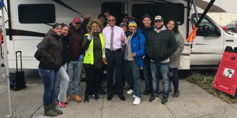 Senator Jackson poses for a photo outside the Winnebago used by the Washington Heights Corner Project for harm reduction work with drug users.