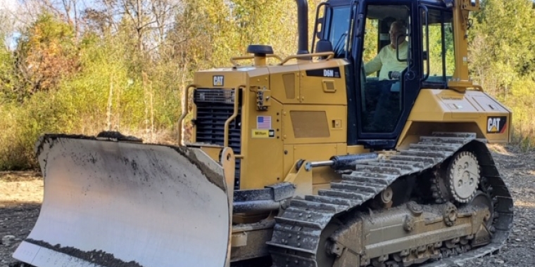 Senator O’Mara gets a look from the operator’s seat at the district’s new large-scale bulldozer. 