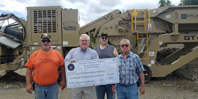 In the photo above at today’s ceremony marking the arrival of the new gravel crusher in the background, from left to right: Dansville Highway Superintendent Ray Acomb, Senator O’Mara, Town of Wayland Highway Superintendent Ray Thielges, and Town of Cohocton Supervisor Tom Johnson. In the photo above at today’s ceremony marking the arrival of the new gravel crusher in the background, from left to right: Dansville Highway Superintendent Ray Acomb, Senator O’Mara, Town of Wayland Highway Superintendent Ray Thielges, and Town of Cohocton Supervisor Tom Johnson.