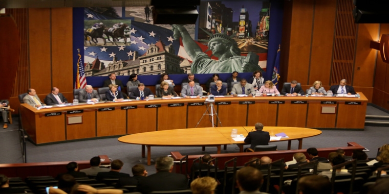 The Senate Energy and Telecommunications Committee, including Senator O'Mara (third from the left), conducts a confirmation hearing for Governor Cuomo's nominee to head the state Public Service Commission.