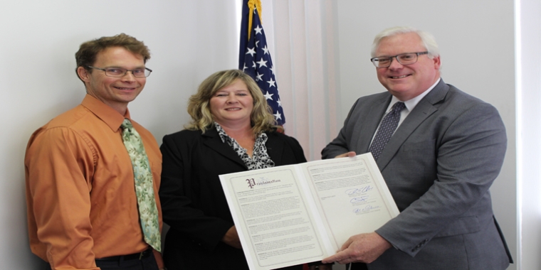 At Senator O’Mara’s district office in Elmira on Wednesday, Assemblyman Friend (far left) and Senator O’Mara present a Legislative Proclamation to Carrie Parkhurst honoring her NYACCE “Student of the Year” award.