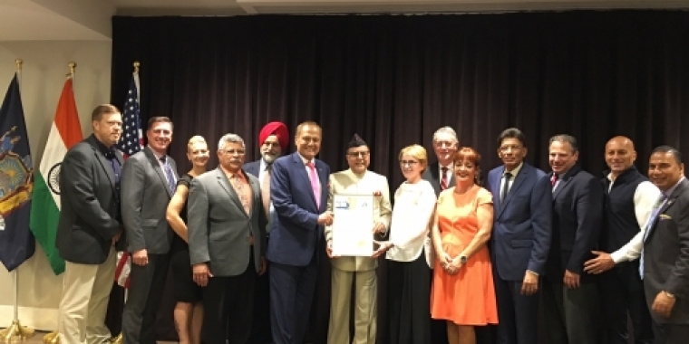 Senator Bonacic (center, pink tie) presents a Senate Proclamation Dr. Subhash Chandra (holding proclamation). Also pictured is Orange County Clerk Annie Rabbitt (orange dress)