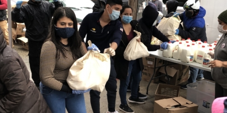 State Senator Jessica Ramos handing food out in front of her district office
