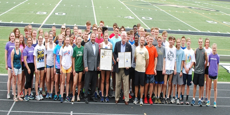 On the track at the Corning-Painted Post High School on Tuesday, May 28, from left to right in the center of the front row, Assemblyman Palmesano, Lindsey Butler, Senator O’Mara, and Head Track and Field Coach Joe Melanson are joined by Lindsey’s track and field teammates.