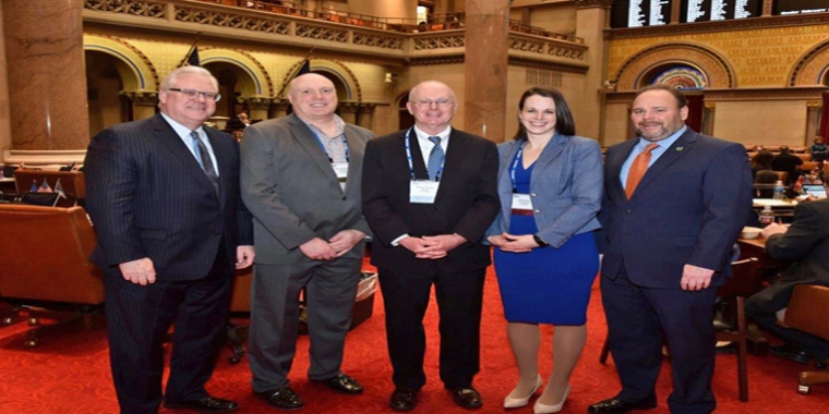 In the photo above in the state Assembly Chamber, from left to right: Senator O’Mara, Corning City Manager Mark Ryckman, Corning Mayor Bill Boland, Corning City Councilmember Alison Hunt, and Assemblyman Palmesano.