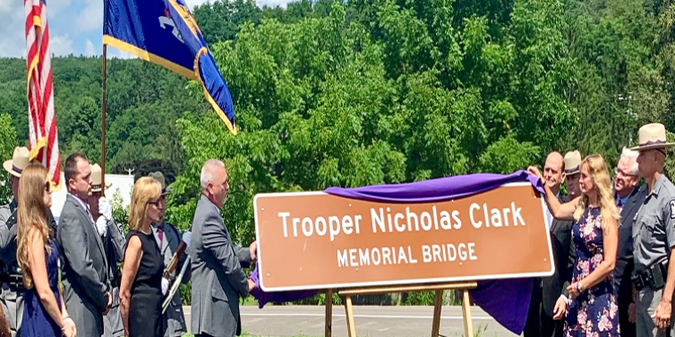 The parents of Trooper Nicholas Clark unveil the new memorial sign at yesterday's ceremony.
