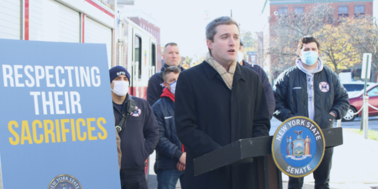 Senator Skoufis stands with DMNA firefighters