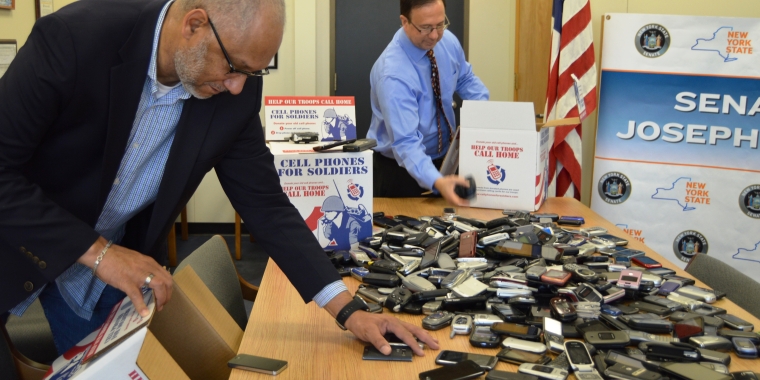 Senator Joseph Griffo, center, and AT&T representative Greeley Ford box hundreds of donated cell phones to help troops call home for holidays. The phones will be recycled in exchange for about 42,000 minutes of free calling cards for overseas troops.