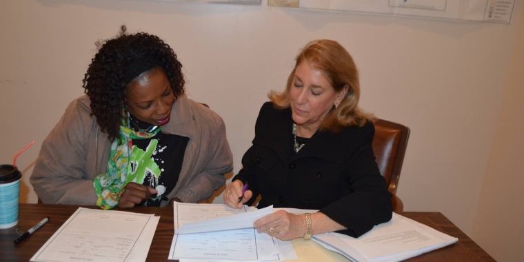 Carmella McFadyen, ESQ, Staff Attorney with Legal Services for the Elderly in Queens, assists resident Debbie Jenkins with property tax concerns.
