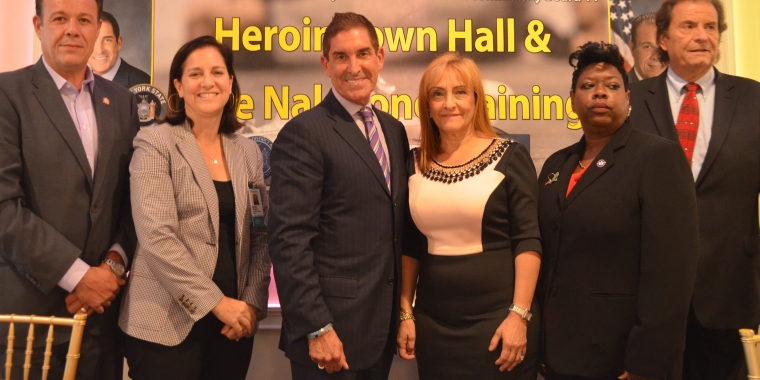 Photo caption (l-r): Assemblyman Mark Gjonaj, Sarah Church, Ph.D. (Montefiore Medical Center), Senator Jeff Klein, OASAS Commissioner Arlene González-Sánchez, Bronx District Attorney Darcel Clark, and Luke Nasta (Camelot of Staten Island, Inc.) address the audience at the heroin town hall.