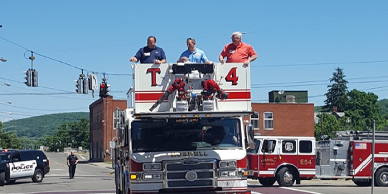 From left to right: Assemblyman Phil Palmesano, Hornell Deputy Mayor John Buckley and Senator O'Mara show off the Hornell Fire Department's new ladder truck during the city's 4th of July parade (read more below).