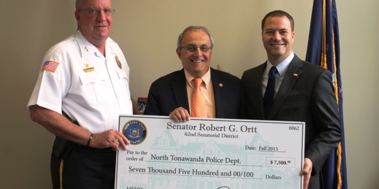 North Tonawanda Police Chief Hall and Mayor Pappas pose with the $7,500 check from Senator Ortt