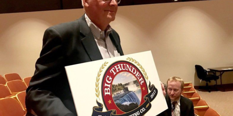 John Robinson of Big Thunder Brewing Co. poses with a copy of the new company's logo. They plan to set up shop inside the former Summit Park Mall.