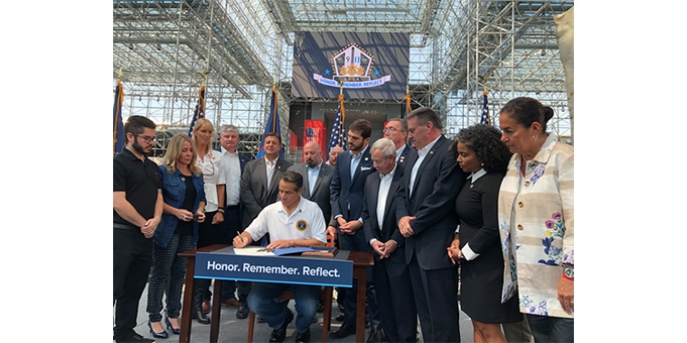 Gov. Andrew Cuomo signed into law four Sept. 11-related bills sponsored by state Sen. Andrew Cuomo (at right of Cuomo). Also pictured are Sept. 11 first responders, health care advocates and lawmakers.