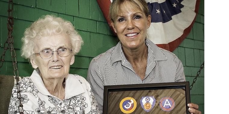 Senator Catharine Young presents Grace Nolan with service ribbons and medals earned by her late husband, Private John Nolan, during World War II.
