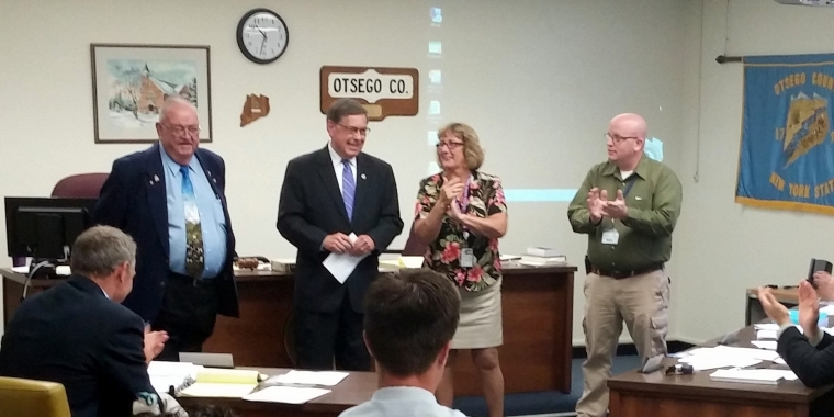 Senator James L. Seward and Assemblyman Bill Magee announce $1 million in state funding to help fund a major upgrade to Otsego County’s telecommunications system. From left, Assemblyman Magee, Senator Seward, Otsego County Board of Representatives Chairman Kathy Clark, and Otsego County Director of E-911 Communications Robert O’Brien.