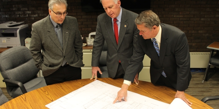 Town of Clarence Supervisor Patrick Casilio, Senator Ranzenhofer and Judge Powers examine blueprints for the new facility. A ground breaking is expected this year with a completion date of twelve to fourteen months later.