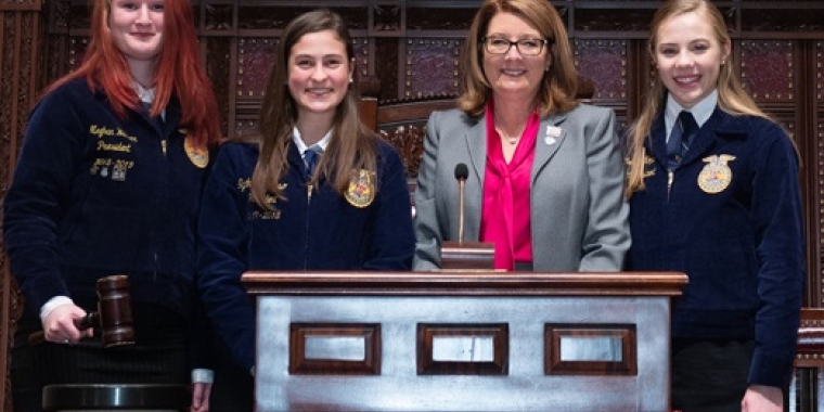 Senator Pam Helming stands in the New York State Senate Chamber with Tully Junior-Senior High School Future Farmers of America members Meghan Weaver, left, and Sydney Grosso, center, and Southern Cayuga Junior-Senior High School FFA member Catherine Kopp.