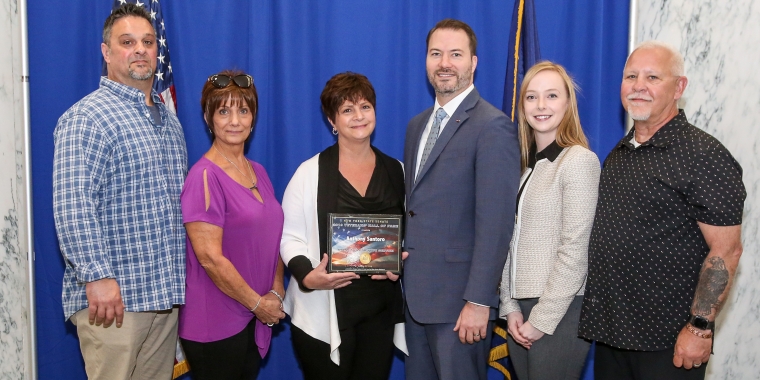 Sen. Rob Ortt presents a 2019 Veterans’ Hall of Fame Award to the family of PFC Anthony Santoro