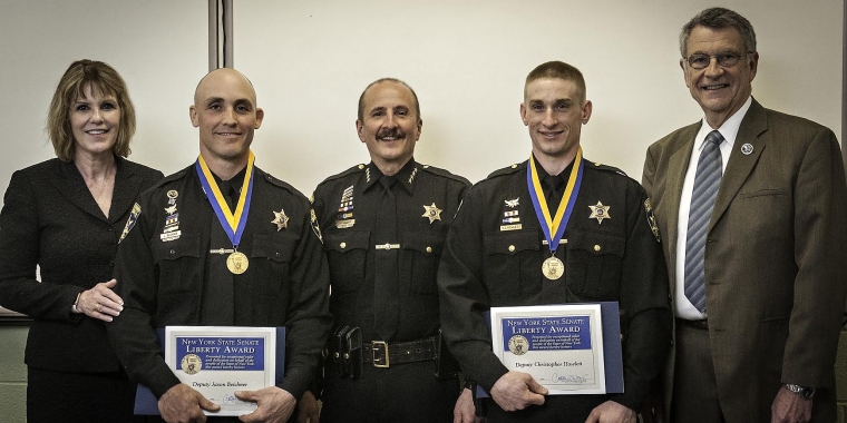 Senator Catharine Young, pictured here with Chautauqua County Sheriff Joseph Gerace and Chautauqua County Executive Vince Horrigan, presented New York State Senate Liberty Medals to Chautauqua County Sheriff Deputies Jason Beichner and Christopher Howlett honoring the deputies heroic actions saving a motorcyclist last November.