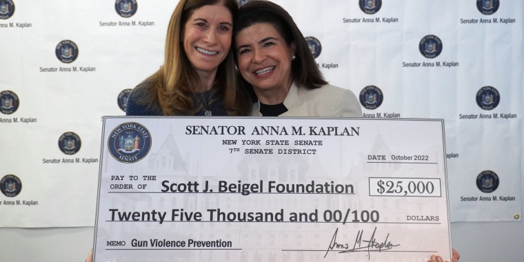 Linda Beigel Schulman receives a $25,000 check from Senator Kaplan for the Scott J. Beigel Memorial Fund