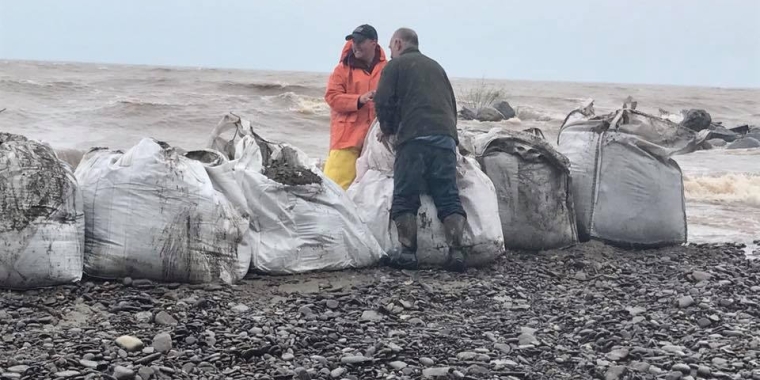 Workers and volunteers put one-ton sandbags near the docks at Bald Eagle Marina in Orleans County for added protection.