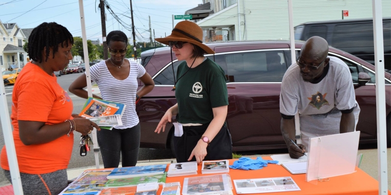 Gina Baldwin, center, explains how to use compost to the many residents who attended the event on Saturday in Far Rockaway.