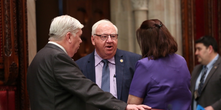 Senator Brooks confers with staff prior to vote on S1687