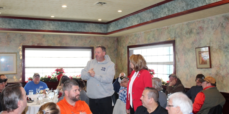 Senator Pam Helming with Town of Venice President Steve Fedrizzi speaking at the Cayuga County Town Highway Superintendents’ Association’s Christmas luncheon.