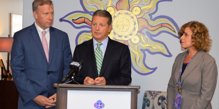Senator Gallivan announces funding for the Family Justice Center as Senator Jacobs and FJC Executive Director Mary Travers Murphy looks on.