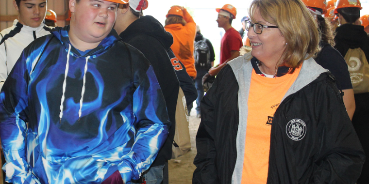 Senator Pam Helming speaking with a student about his plans for after high school