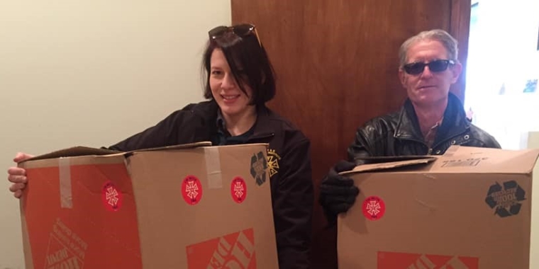 Leah Okin, left, and Frank Gallagher, business representatives with the Theatrical Wardrobe Union, Local 764, IATSE display a small portion of the entire sizable donation of assorted goods their members collected for federal workers impacted by the government shutdown.