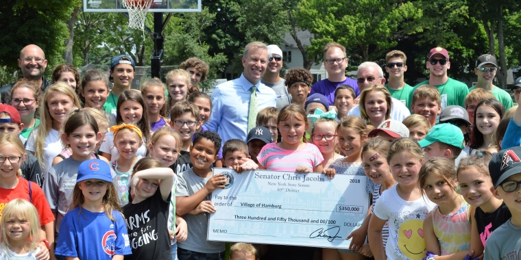 Senator Jacobs is pictured with lots of happy children at Hamburg Village Community Center Park announcing $350,000 in state funds to support new and improved recreational facilities in the Village of Hamburg.