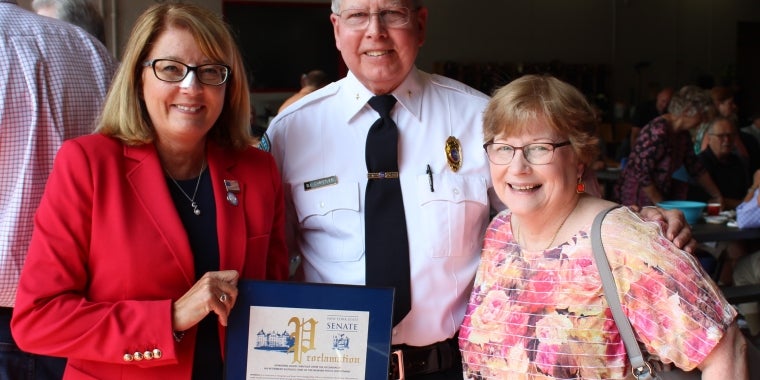Senator Pam Helming presents a New York State Senate Proclamation to Newark Police Chief David Christler and his wife, Diane, to recognize his retirement and honor his law enforcement career with the New York State Police and Newark Police Department.