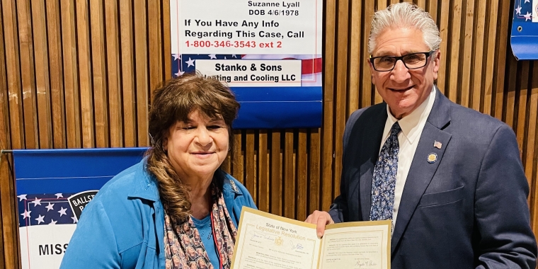 Senator Jim Tedisco presenting a NYS Senate resolution he authored to Mary Lyall commemorating Missing Persons Day in New York State