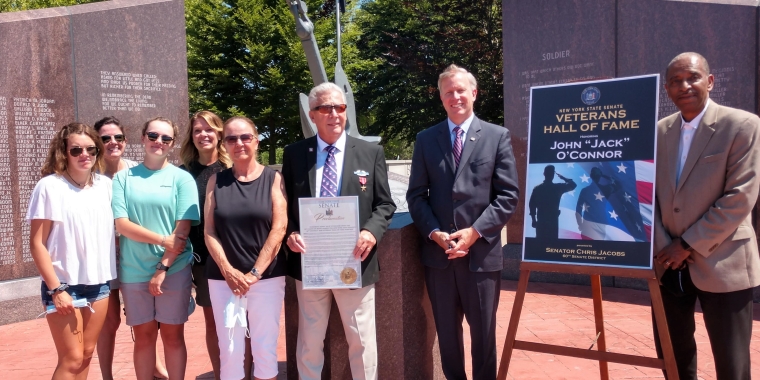 Photo Caption - L-R: Granddaughter Allie, daughter Kelly, granddaughter Kate, daughter Colleen, wife Patricia, 2020 New York State Veterans Hall of Fame Inductee Jack O'Connor, State Senator Chris Jacobs and Buffalo City Court Judge Robert Russell pictured in front of the Vietnam Memorial at the Buffalo and Erie County Naval & Military Park.