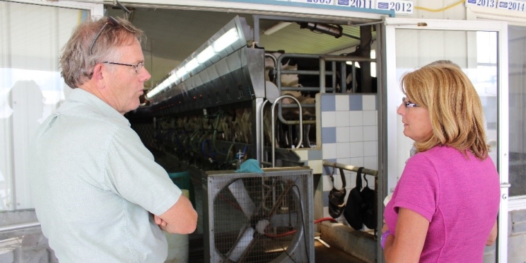 Senator Pam Helming talks with Don Jensen, owner of Lawnhurst Farms in Stanley, about the anaerobic digester on his dairy farm during a tour in August 2017.