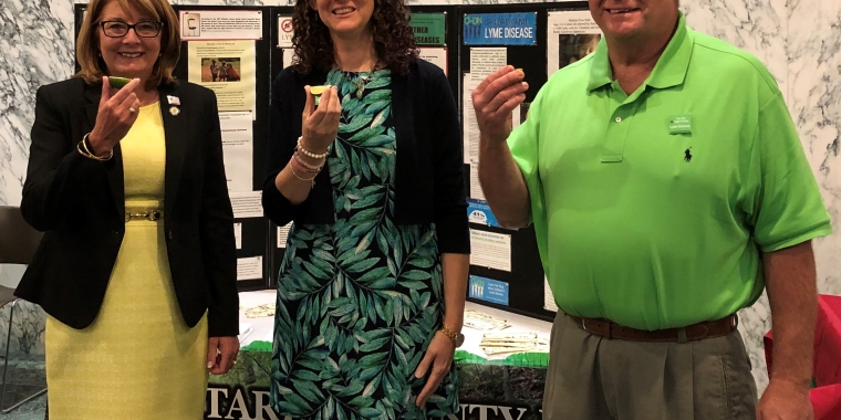 Senator Pam Helming, Maureen Kanaley-Messina, and John Messina take part in the Take a Bite Out of Lyme Disease Challenge during Lyme Advocacy Day at the State Capitol in Albany on June 3, 2019.