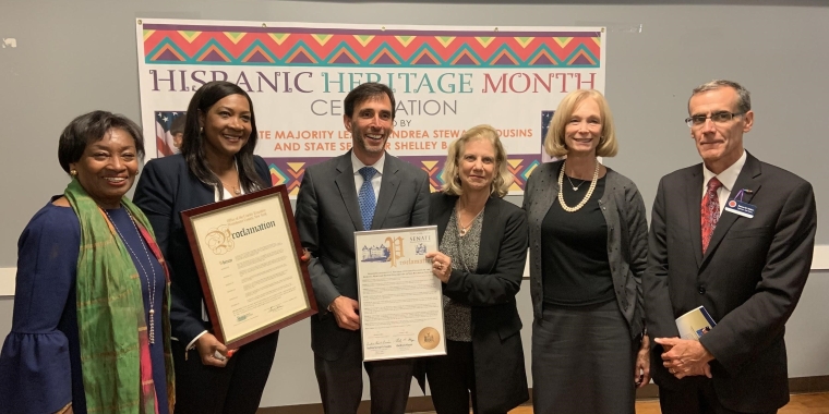 Majority Leader Stewart-Cousins and Senator Mayer presenting Jackeline Agudelo with a NYS Senate Proclamation. From left: Majority Leader Andrea Stewart-Cousins; Jackeline Agudelo, Executive Director of the United Community Center in Westchester; New Rochelle Mayor Noam Bramson; State Senator Shelley B. Mayer; Ellen Hendrickx, Greenburgh Town Council; Damon Maher, Westchester County Legislator