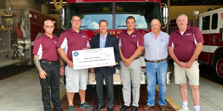 Standing in front of a Miller Hose Fire Truck from left: Miller Hose Fire Co. Pres. Jim Enderton, Fire Chief Jason Seib, Senator Rob Ortt, 1st Assistant Fire Chief Jason Coleman, Pump Operator/Driver Ed Eifert and Interior Firefighter/Driver Mark Phelps.