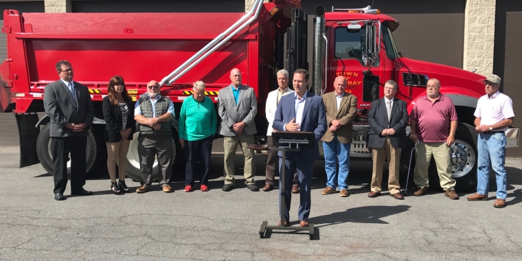 Senator Ortt stands in front of the Town of Murray's new dump truck with several local officials from Orleans County behind him.