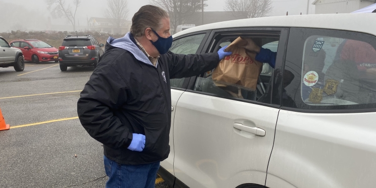 State Sen. Harckham accepting a food donation from a Carmel resident