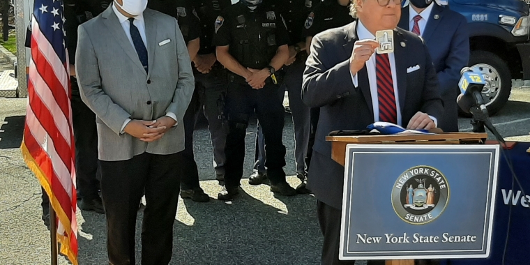 Sen. Harckham holds up a naloxone kit during the awards ceremony at Westchester County Police Headquarters.